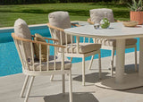 Apple Bee Zanzibar Dining Tuintafel 220 cm Cintered Stone Oyster met stoelen naast een zwembad.